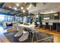 Open-concept living space with modern lighting, a sleek dining table, and a stylish kitchen island at 310 Arlington Ave # 318, Charlotte, NC 28203