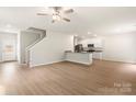 Spacious living room with an open floor plan, hardwood floors, and a ceiling fan at 3263 Maple Ridge Dr, Gastonia, NC 28052