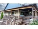 Large wooden back deck with railings, ceiling fan, and plenty of space for entertaining at 406 Third Ne Ave, Conover, NC 28613