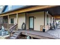 Side porch with exterior wall, glass doors, and wooden steps leading to the landscaped grounds at 406 Third Ne Ave, Conover, NC 28613