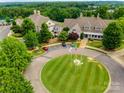 Overhead shot of community clubhouse with manicured landscaping, parking, and other recreational facilities at 5082 Mariana Ct, Tega Cay, SC 29708
