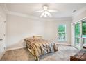 Cozy bedroom with neutral carpet, a queen-sized bed, and outdoor balcony access at 537 Southeast Dr # 537, Davidson, NC 28036