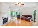 Living room with fireplace, hardwood floors, and sliding door to outdoor living area at 537 Southeast Dr # 537, Davidson, NC 28036