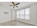 Bright bedroom with large windows, modern ceiling fan, and light gray wood flooring at 6814 Piper Thorn Way, Indian Land, SC 29707