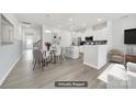 Modern kitchen with white cabinets, stainless steel appliances, and an island with bar seating at 6814 Piper Thorn Way, Indian Land, SC 29707