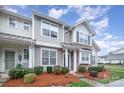 Attractive townhome featuring neutral siding, well-maintained landscaping, and a cozy front porch at 706 Cherryfield Pl, Rock Hill, SC 29732