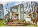 Beautiful two-story home with a well-maintained lawn, stone flower beds, and a two car garage at 7541 Thorn Creek Ln, Tega Cay, SC 29708
