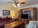 Well-lit living room showcases a ceiling fan and an entertainment center at 8522 Stonehurst Dr, Charlotte, NC 28214