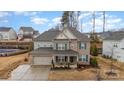 Attractive two-story home with a brick and siding exterior, complemented by blue shutters and a well-manicured lawn at 8651 Shadetree St, Huntersville, NC 28078