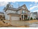 Beautiful two-story home with a brick and siding exterior, complemented by blue shutters and a well-manicured lawn at 8651 Shadetree St, Huntersville, NC 28078