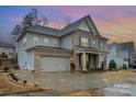 Stylish two-story home with a spacious garage, brick accents, and manicured landscaping for curb appeal at 8651 Shadetree St, Huntersville, NC 28078