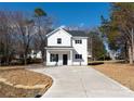 Beautiful two-story home with a new driveway, landscaped front yard, and a covered porch entry at 8705 Moody Rd, Charlotte, NC 28215