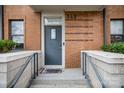 Close up of townhome brick front entrance with concrete steps and wrought iron railing at 946 E 8Th St, Charlotte, NC 28204