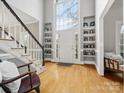 Bright foyer with soaring windows, custom shelving, and beautiful hardwood floors at 9743 Aegean Ct, Huntersville, NC 28078