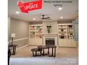 Spacious living room featuring a fireplace with marble surround and built-in bookcases at 9743 Aegean Ct, Huntersville, NC 28078