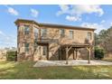 Home with a covered patio and green grass at 12515 Hashanli Pl, Matthews, NC 28105