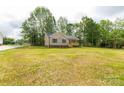 A charming single-story home surrounded by trees and an expansive lawn at 1323 Mack Dr, McConnells, SC 29726