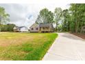 Attractive single-story home with a long driveway and lush, green surroundings at 1323 Mack Dr, McConnells, SC 29726