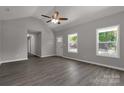 Well-lit living room with gray walls, wood-look flooring, large windows, and a ceiling fan at 1323 Mack Dr, McConnells, SC 29726