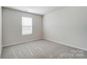Cozy bedroom with plush carpet and ample natural light from the window at 1471 Honey Trl, Monroe, NC 28112