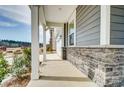 Inviting covered front porch with stone accents and natural light at 1471 Honey Trl, Monroe, NC 28112