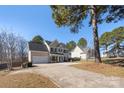 Traditional two-story home featuring neutral siding, black shutters, and a concrete driveway at 152 Painted Bunting Dr, Troutman, NC 28166