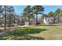 Spacious two-story home with well-maintained lawn, attached garage, and long driveway at 152 Painted Bunting Dr, Troutman, NC 28166