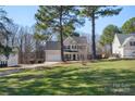Spacious two-story home with well-maintained lawn, attached garage, and long driveway at 152 Painted Bunting Dr, Troutman, NC 28166