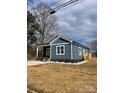 Charming single-story home with blue siding and white trim surrounded by dry grass at 1530 W Horah St, Salisbury, NC 28144