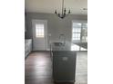 Bright kitchen featuring a granite-topped island with a stainless steel sink and modern lighting at 1530 W Horah St, Salisbury, NC 28144