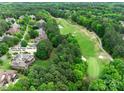 Aerial view of the neighborhood showcasing mature trees, golf course access, and the home's location at 16824 Ashton Oaks Dr, Charlotte, NC 28278