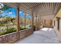 Covered patio with brick accents overlooking the lake at 171 Agnew Rd, Mooresville, NC 28117