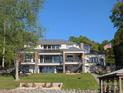 Expansive modern lake house with multiple levels, outdoor decks, and beachfront access, perfect for waterfront living at 180 Willow Point Rd, Troutman, NC 28166