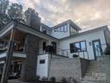 A partial home view showing stone accents, exterior stairs, and a deck at 180 Willow Point Rd, Troutman, NC 28166