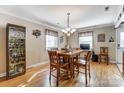 Inviting dining area featuring hardwood floors, modern lighting, and a classic table set at 211 Spring St, Belmont, NC 28012