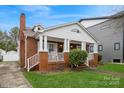 Brick home with covered front porch, showcasing its architectural details and well-maintained lawn at 2125 Shenandoah Ave, Charlotte, NC 28205