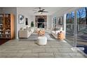 Staged living room featuring a fireplace with built-in shelves and a sliding glass door to the deck at 26017 Misty Way Dr, Fort Mill, SC 29708