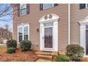 Elegant front entrance featuring a white door frame and decorative landscaping at 2692 Norman Isle Dr, Denver, NC 28037