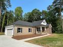 Beautiful single-Gathering home with a two-car garage, brick facade, and fresh landscaping at 309 General As Johnston St, Stanley, NC 28164