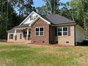 Attractive home featuring brick and stone facade, black shutters, and manicured landscaping at 309 General As Johnston St, Stanley, NC 28164