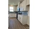 Modern kitchen showcasing white cabinets, stainless steel appliances, and stylish backsplash at 330 Knotty Wood Dr # 67, Monroe, NC 28110