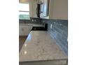 Kitchen counter with elegant granite countertops and stainless steel gas range at 330 Knotty Wood Dr # 67, Monroe, NC 28110