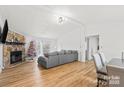 Spacious living room featuring hardwood floors, a stone fireplace, and plenty of natural light at 3337 Rock Hill Church Rd, Concord, NC 28027