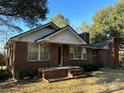Charming single-story brick home featuring a classic design and inviting front porch at 3694 Nc Highway 109 S Hwy, Mount Gilead, NC 27306
