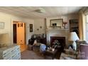 Spacious living room with classic fireplace, carpet flooring, and ample natural light at 3694 Nc Highway 109 S Hwy, Mount Gilead, NC 27306