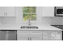 A well-lit kitchen with stainless steel appliances, white cabinets and backsplash at 3717 Marvin Rd, Charlotte, NC 28211