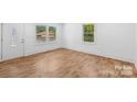 Bright living room with hardwood floors, a large window and white trim at 3717 Marvin Rd, Charlotte, NC 28211