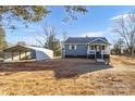 Exterior view of the house showing the detached carport in the expansive yard at 445 Cannon Farm Rd, China Grove, NC 28023