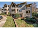 Multi-level condo with brick accents, balconies, and well-maintained landscaping at 5009 Sharon Rd # E, Charlotte, NC 28210