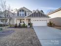 Exterior shot of a home with a well-maintained lawn, neutral siding, and welcoming front porch at 5028 Colline Ct, Charlotte, NC 28216